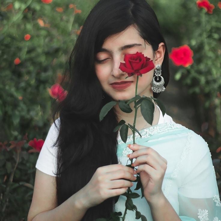 Asha Nair, Lead Design Curator at Steady Orbit Paper, reviewing corporate floral arrangements